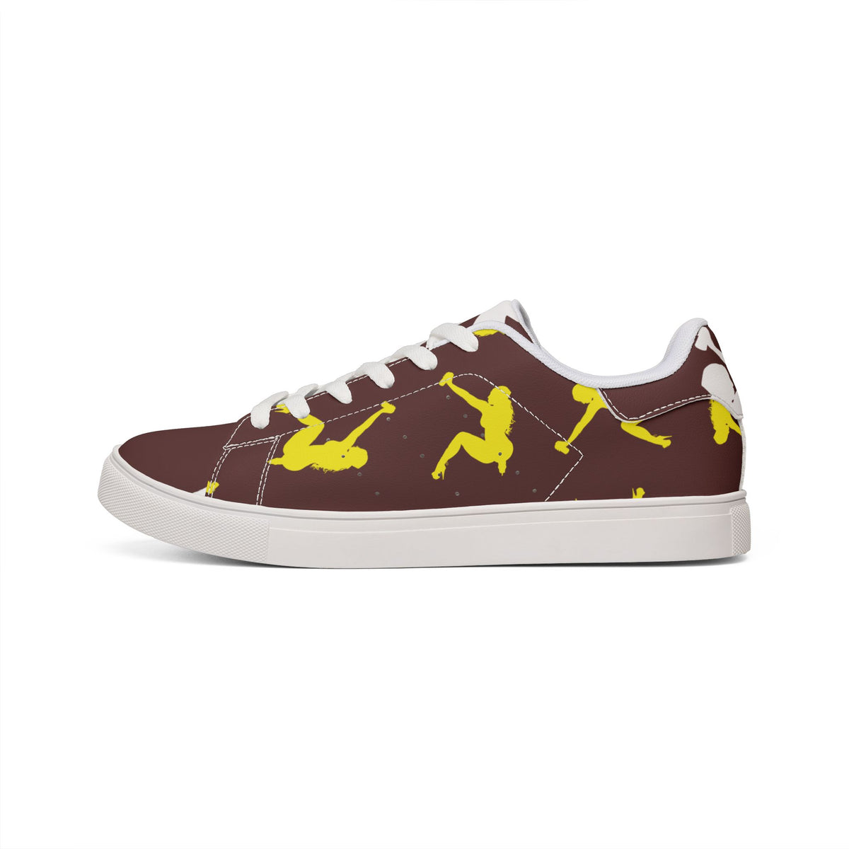 A pair of low-top sneakers shown from a top-down view. The shoes feature a dark brown upper with white laces, white collar lining, and a bright yellow graphic accent on the outer side of the right shoe.