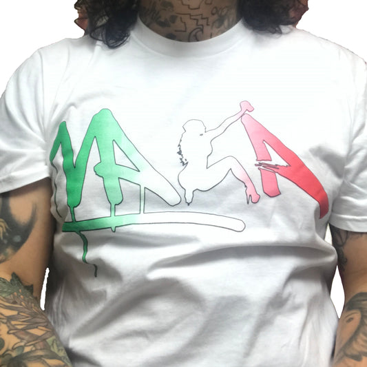 A white t-shirt with the name 'VAKA' written in a stylized graffiti tag font in green, white, and red colors, and a silhouette of a spray-painting pin-up figure in the center.