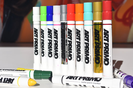 A collection of Art Primo Solid Paint Markers in various colors, displayed horizontally with the brand name visible on the packaging.
