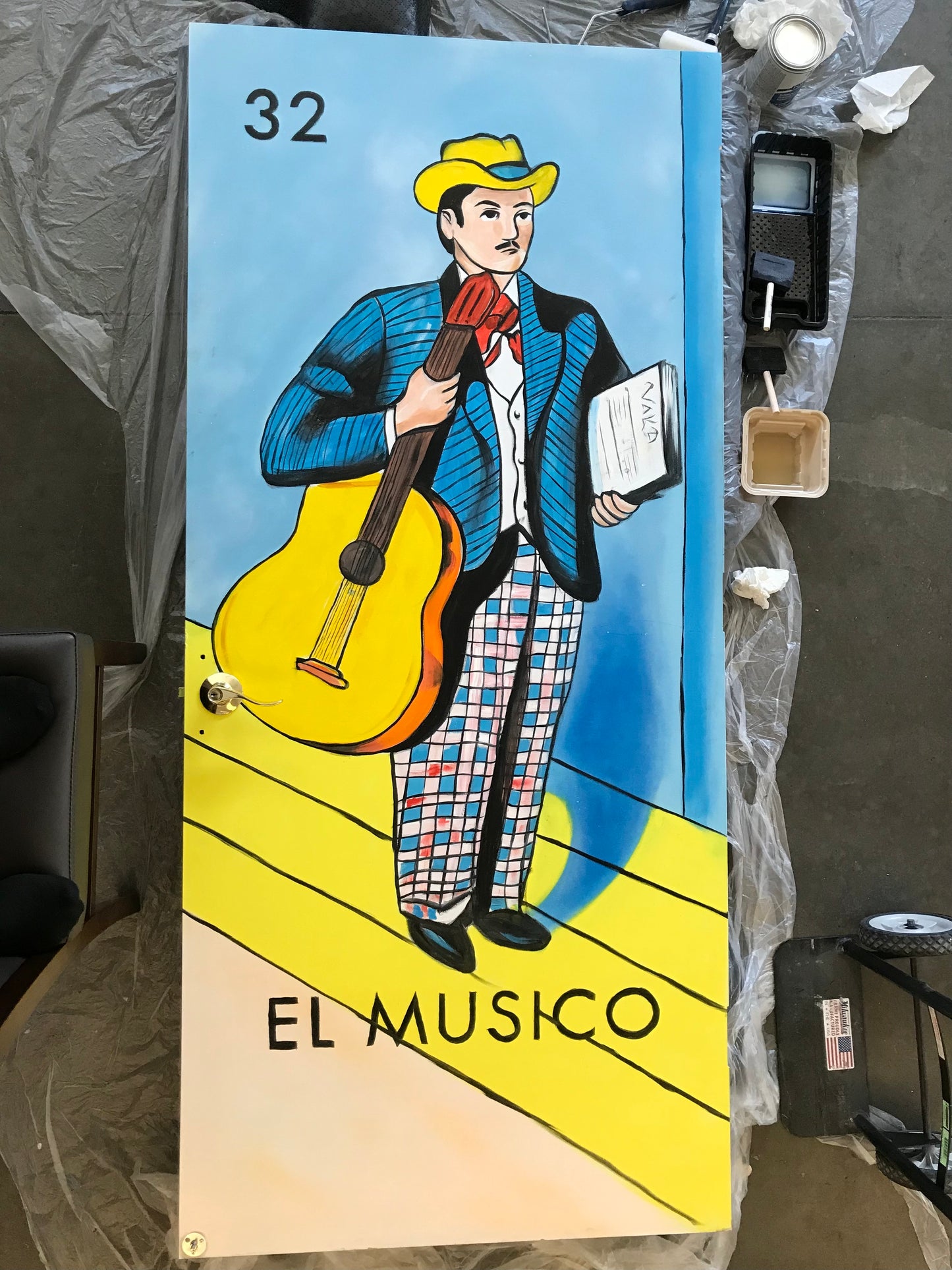 Cartoon character holding a guitar with text 'El Musico' on a blue and yellow background