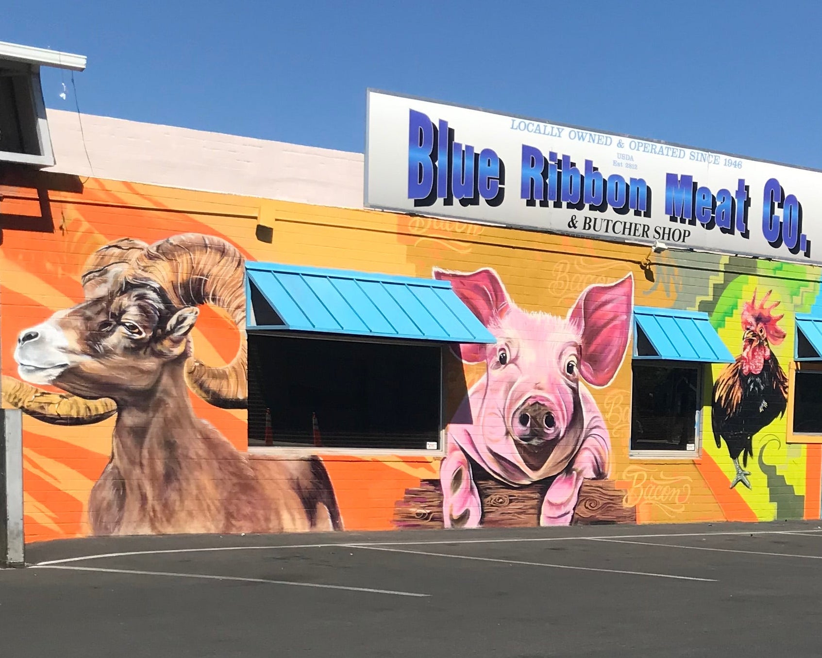 Mural of a goat, pig, and rooster on the side of Blue Ribbon Meat Co. building.