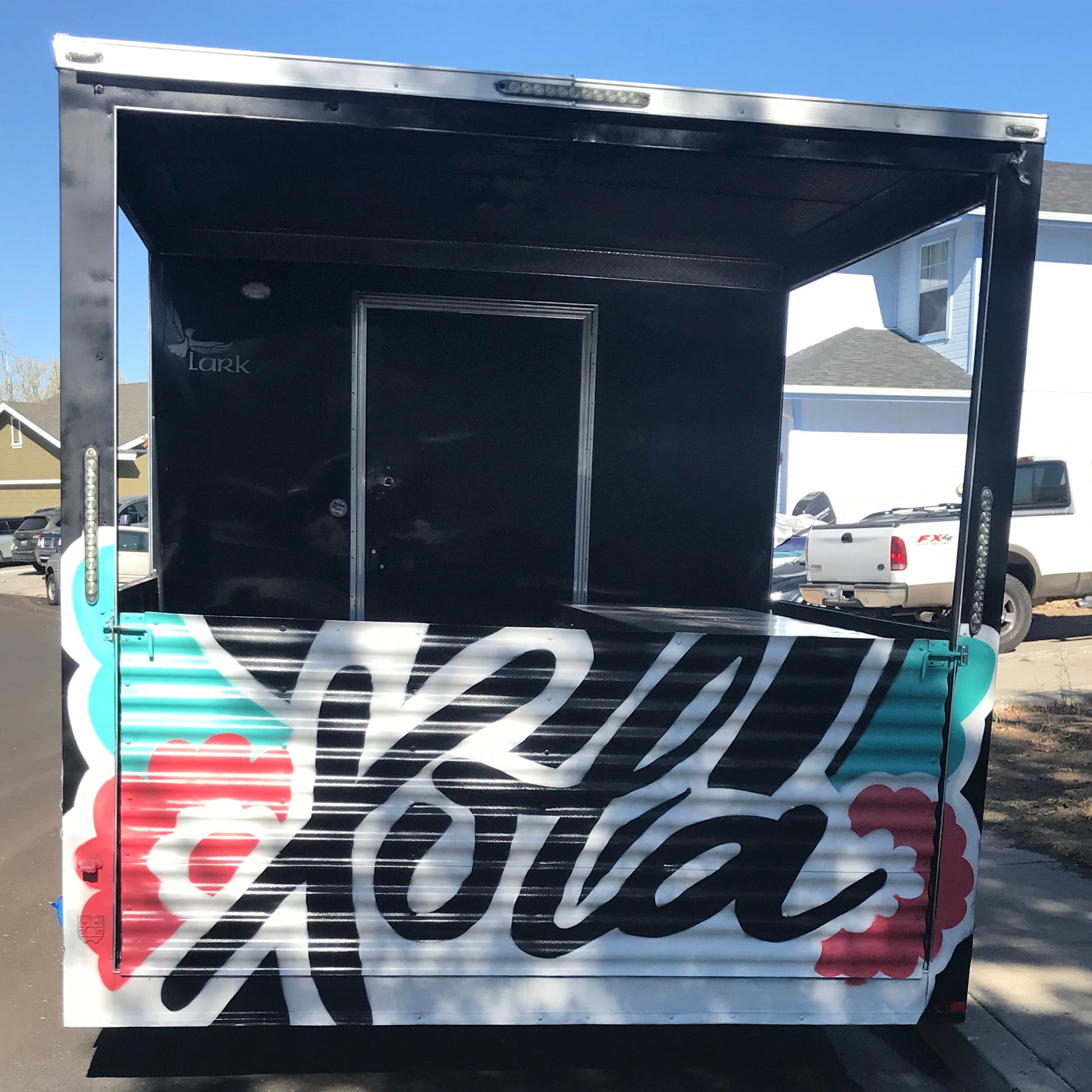 Truck with colorful graphics and text on a clear day