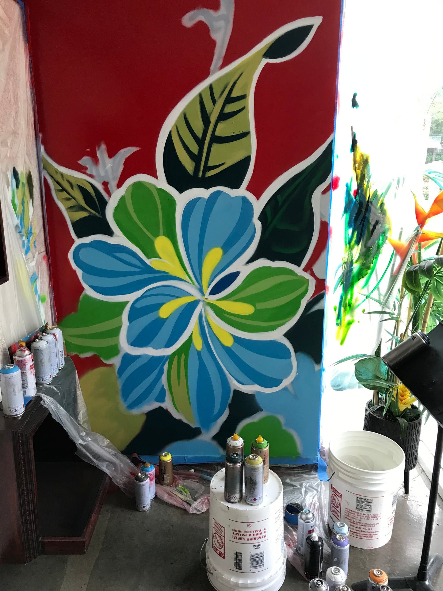 Floral design being printed on a large banner with printing equipment in the background.