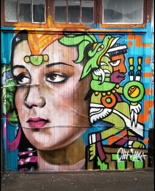 Colorful mural of a woman's face with abstract elements on a door.